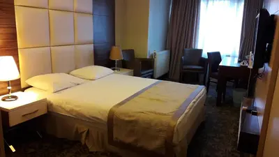 a hotel room with a large bed in a room at Derpa Suite Hotel in Istanbul