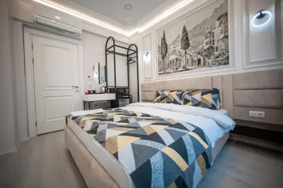 a bedroom with a bed with a blue and yellow comforter at Megalos Galata Hotel in Istanbul