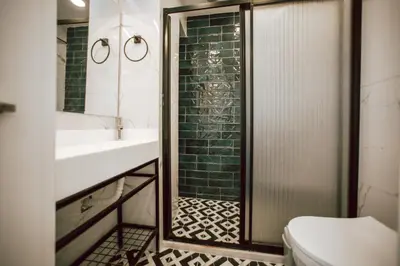 a bathroom with a shower and a toilet and a sink at Megalos Galata Hotel in Istanbul