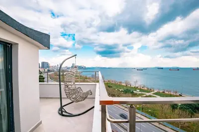 a balcony with a view of the water at Homie Suites - Newly Built Seaside Apartments on Bakırköy Shore in Istanbul