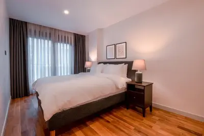 a bedroom with a large white bed and a window at Homie Suites - Newly Built Seaside Apartments on Bakırköy Shore in Istanbul