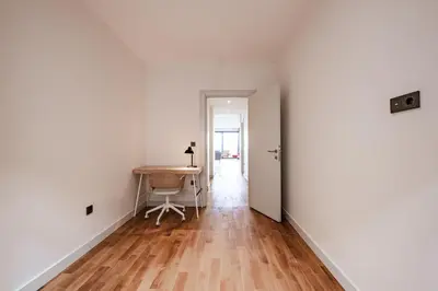 an empty room with a table and a hallway at Homie Suites - Newly Built Seaside Apartments on Bakırköy Shore in Istanbul