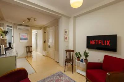 a living room with a red couch and a netflix sign on the wall at Lemon Apartments in Istanbul