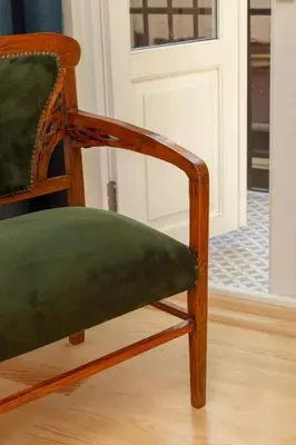 a wooden chair with a green seat in front of a door at Lemon Apartments in Istanbul