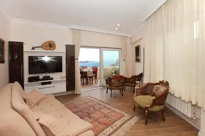 a living room with a couch and a tv at Lir Residence Suites LONG STAY in Istanbul