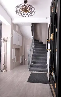 a hallway with a staircase with a chandelier at BGuest Hotel & Residence in Istanbul