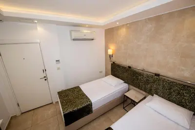 a hotel room with a bed and a door and a room at BGuest Hotel & Residence in Istanbul