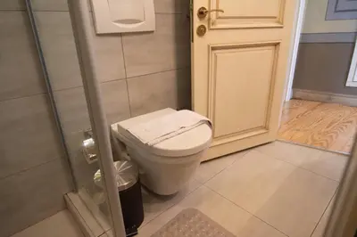 a small bathroom with a toilet and a shower at Stylish City Getaway-Explore the Urban Delights in Istanbul