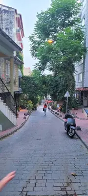 a person walking down a street with a tree at Stylish City Getaway-Explore the Urban Delights in Istanbul