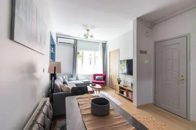 a living room with a couch and a chair and a door at Bright 3BR Apartment Near Kadıköy Seaside in Istanbul