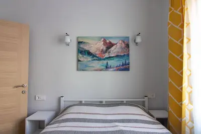 a bedroom with a bed and a painting on the wall at Bright 3BR Apartment Near Kadıköy Seaside in Istanbul