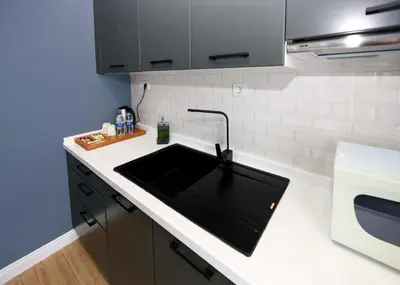 a kitchen with a sink and a microwave at Selvese Suites, Serviced Living in Galata in Istanbul