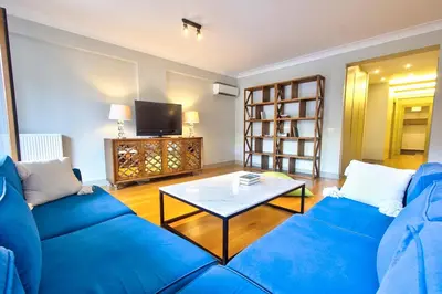a living room with a blue couch and a coffee table at New Build with Modern Amenities and Balcony in Istanbul