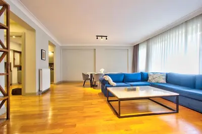 a living room with a blue couch and a table at New Build with Modern Amenities and Balcony in Istanbul