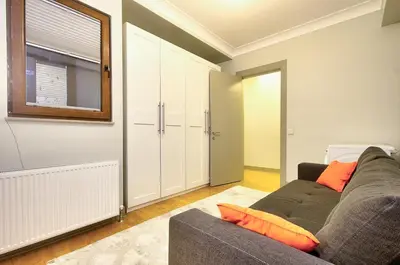a living room with a couch and a window at New Build with Modern Amenities and Balcony in Istanbul