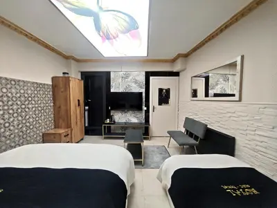 a bedroom with two beds and a skylight at Royal Hotel Kumkapı in Istanbul