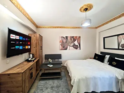 a bedroom with a bed and a flat screen tv at Royal Hotel Kumkapı in Istanbul