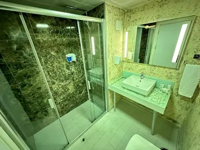 a bathroom with a shower and a sink at Tempo Fair Suites in Istanbul