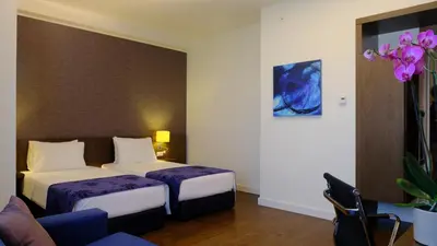 a hotel room with two beds and a couch at FEZ INN Hotel in Istanbul