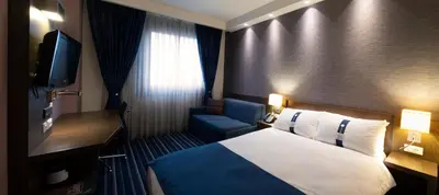 a hotel room with a bed and a television at FEZ INN Hotel in Istanbul