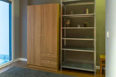 a room with a book shelf and a cabinet at Cosy flat with a garden in central Kadikoy in Istanbul