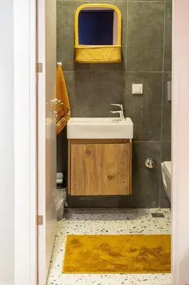 a bathroom with a sink and a mirror at Cosy flat with a garden in central Kadikoy in Istanbul