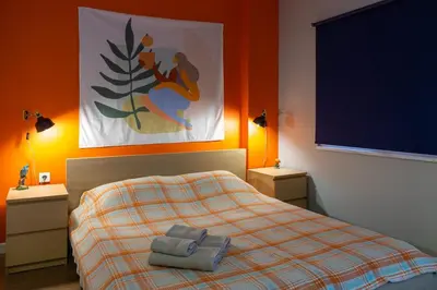 a bedroom with a bed with two towels on it at Cosy flat with a garden in central Kadikoy in Istanbul