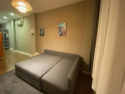 a bedroom with a couch in a room at Cosy flat with a garden in central Kadikoy in Istanbul