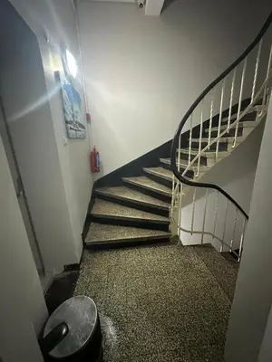 a spiral staircase in a building with a fire extinguisher at Hotel Hoyuk in Istanbul