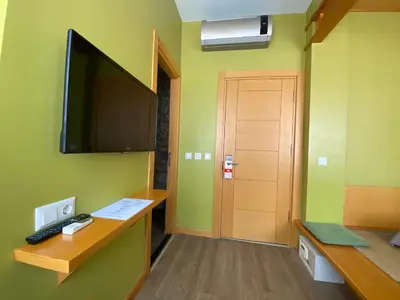 a room with a desk and a television on a wall at Bunkahaus in Istanbul