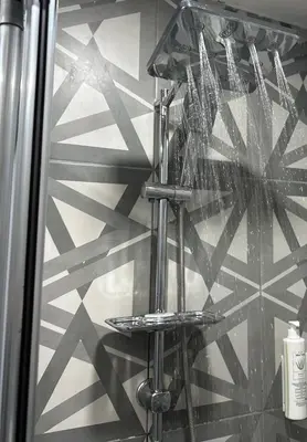 a glass shower in a bathroom with a wall at Monezza Maltepe Rezidans in Istanbul