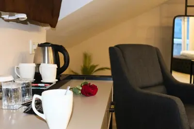 a kitchen with a counter with a coffee maker and a chair at Monezza Maltepe Rezidans in Istanbul