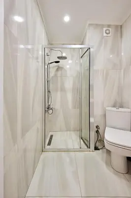 a glass shower in a bathroom with a toilet at Cozy Oasis in Moda Steps to Seafront in Istanbul