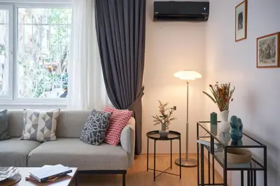 a living room with a couch and a window at Cozy Oasis in Moda Steps to Seafront in Istanbul