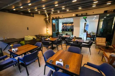a restaurant with tables and chairs and a bar at İSTPORT GARDEN HOTELS in Arnavutköy