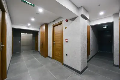 a hallway with a row of doors in a building at İSTPORT GARDEN HOTELS in Arnavutköy