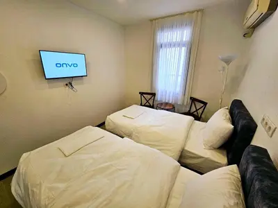 a living room with two beds and a flat screen tv at Noya Suites in Istanbul