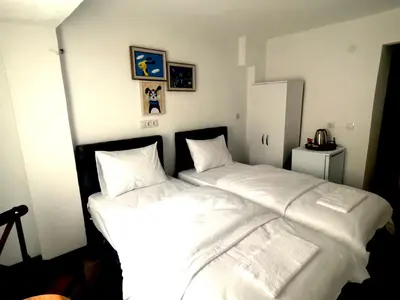 two beds in a room with white sheets and pillows at Noya Suites in Istanbul