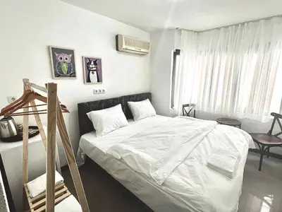 a bedroom with a bed with white sheets at Noya Suites in Istanbul