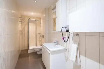 a white bathroom with a sink and a toilet at The Canka Residence And Family Apartment Istanbul City Center - ŞIŞLI in Istanbul