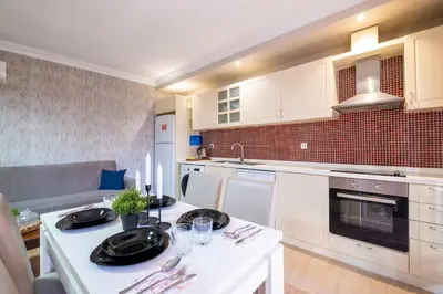 a kitchen with white cabinets and a white counter top at The Canka Residence And Family Apartment Istanbul City Center - ŞIŞLI in Istanbul