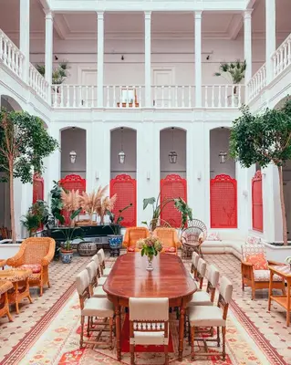 a large room with a wooden table and chairs at Büyükada Splendid Palace Hotel in Buyukada