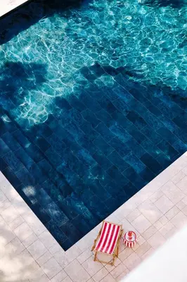 a swimming pool with a chaise lounge and a swimming pool at Büyükada Splendid Palace Hotel in Buyukada