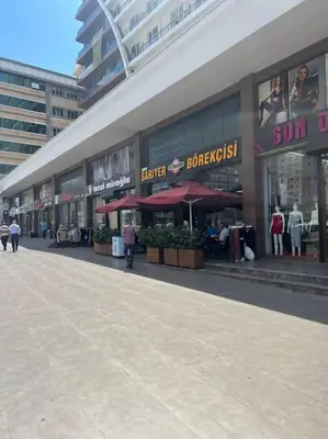a building with umbrellas on a street in a city at Central Location Free WIFI AC Parking Garage in Esenyurt