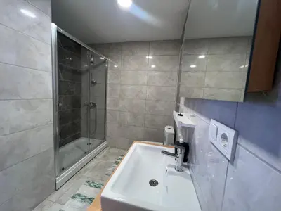 a bathroom with a sink and a shower at Central Location Free WIFI AC Parking Garage in Esenyurt