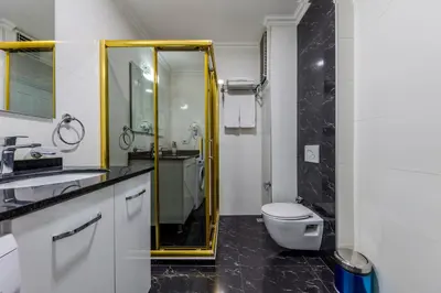 a bathroom with a toilet and a glass shower at Lemis Suite Istanbul in Istanbul
