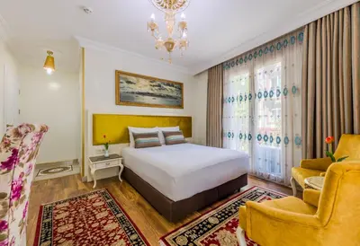 a hotel room with a bed and a chair at Lemis Suite Istanbul in Istanbul