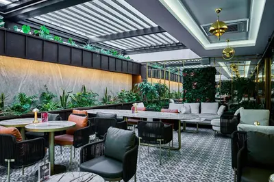 a restaurant with tables and chairs and plants at Rayelin Hotel Istanbul Old City in Istanbul