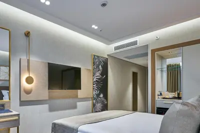 a bedroom with a bed and a tv on the wall at Rayelin Hotel Istanbul Old City in Istanbul