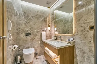 a bathroom with a sink and a toilet and a mirror at Rayelin Hotel Istanbul Old City in Istanbul